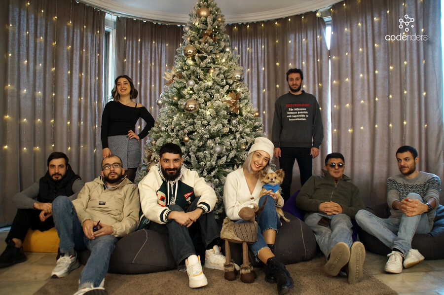 CodeRiders software outsourcing company in the office around the Christmas tree CodeRiders software development team is already ready for Christmas and have just decorated their Christmas tree