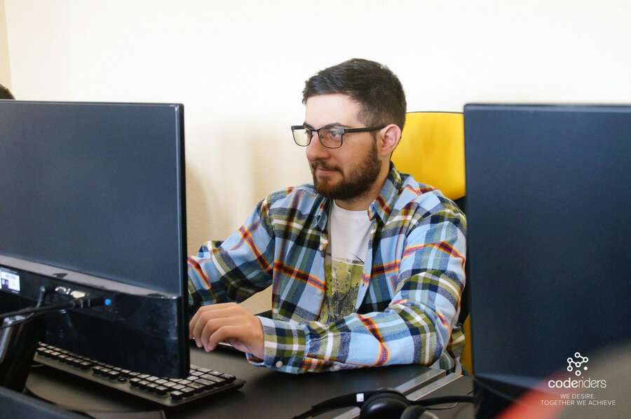 A software engineer from CodeRiders working on a software outsourcing project through staff augmentation model Software development staff augmentation service provider during work