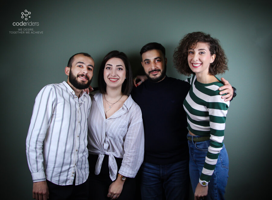 CodeRiders software development company business development executive Anna with her colleagues during a working day Anna from CodeRiders with her colleague software developers at CodeRiders software outsourcing firm